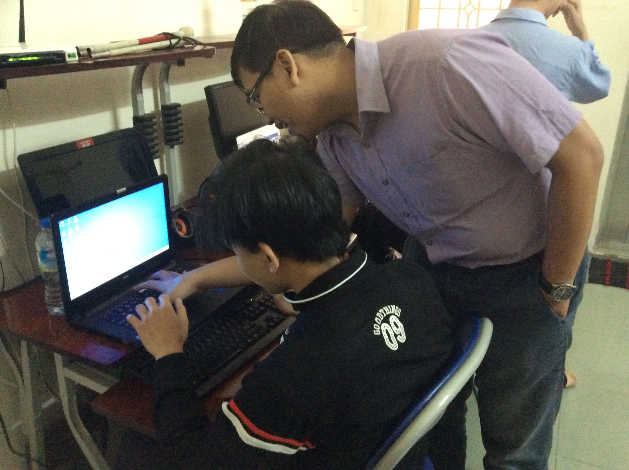 Mr. Vinh is instructing one of the trainees